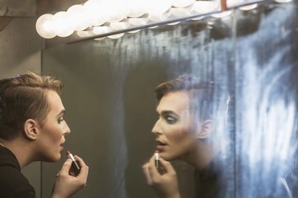 Dragqueen in Berlin Drag queen makes up in front of the mirror in Berlin